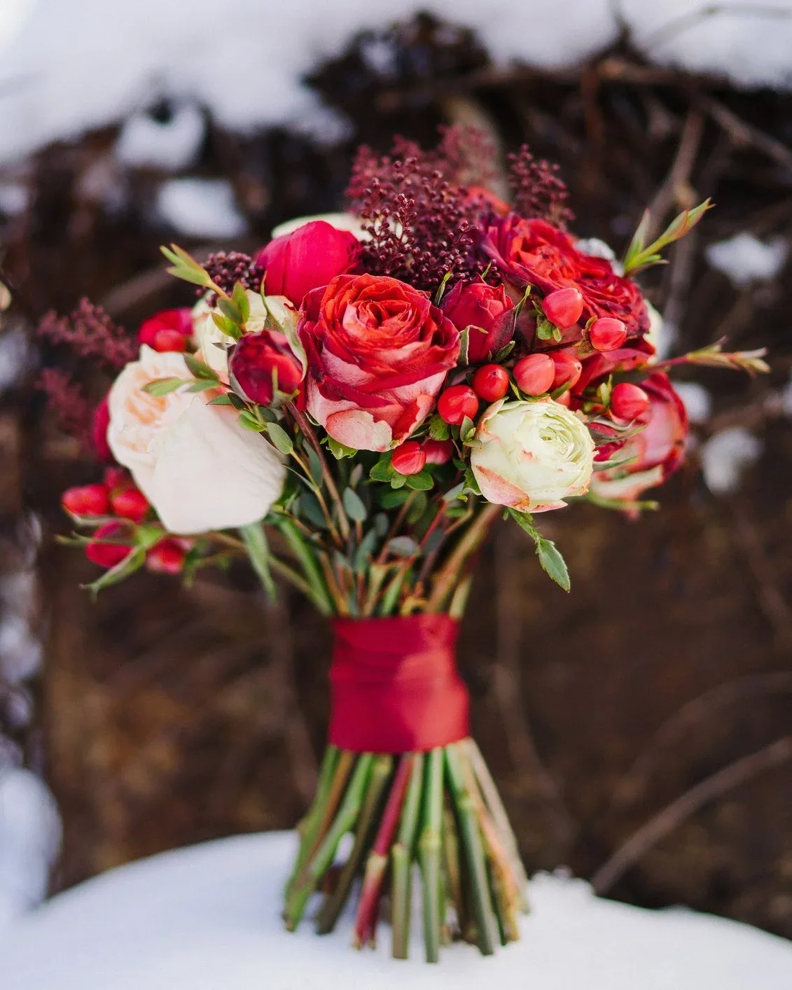 Bride holding a winter bouquet outdoors